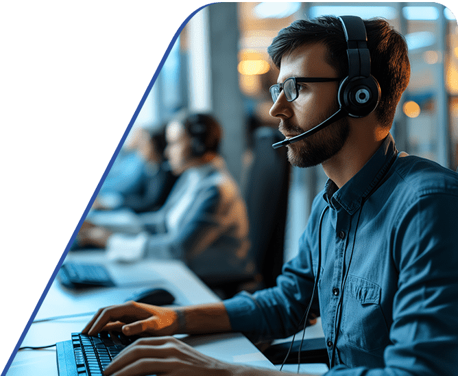 Amtivo (Formerly Certification Europe and EQA) - ISO 27701 Privacy Information Management Systems. A row of workers at their desks with a focus on one with a headset on.